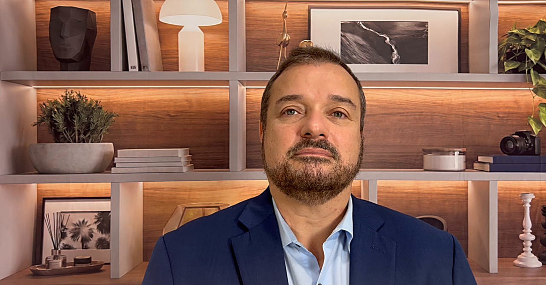 A professional on a video call with a clean QuickStudio backdrop behind him