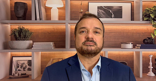 A professional on a video call with a clean QuickStudio backdrop behind him